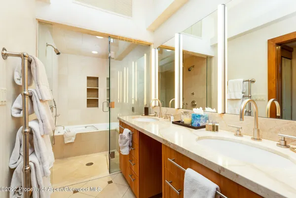 a bathroom with a tub sink and mirror