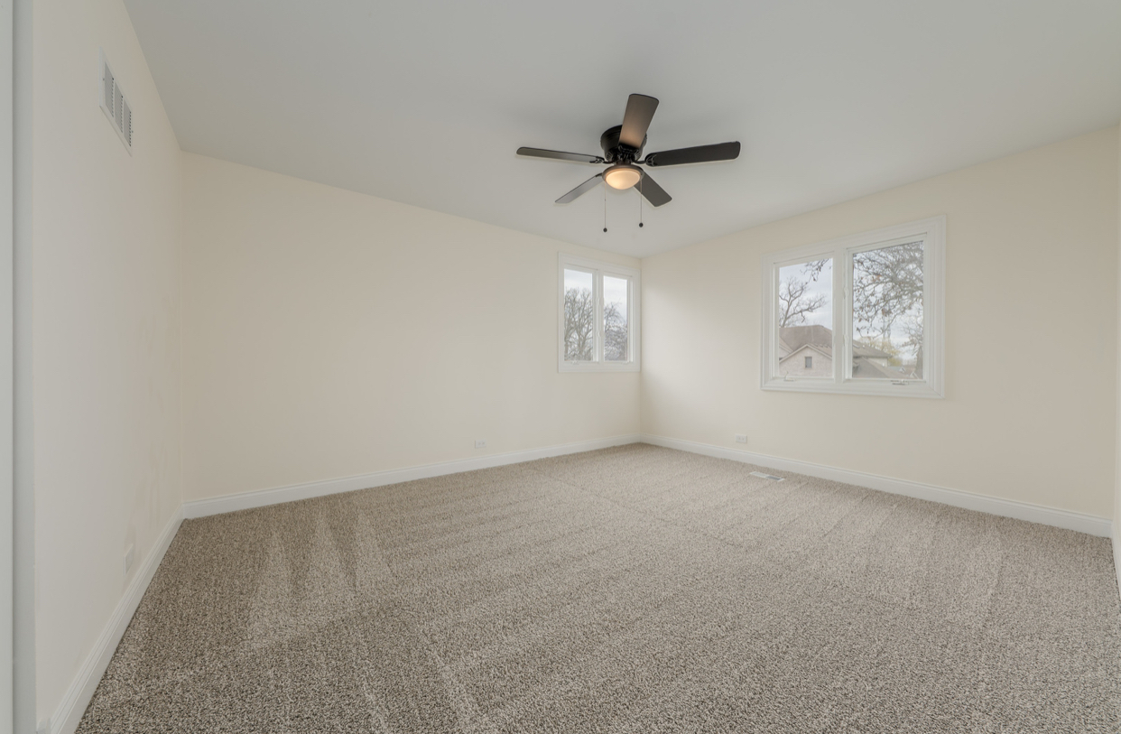 3664 Edward Drive Crete, IL 60417 - Photo 18 of 30 an empty room with windows and fan