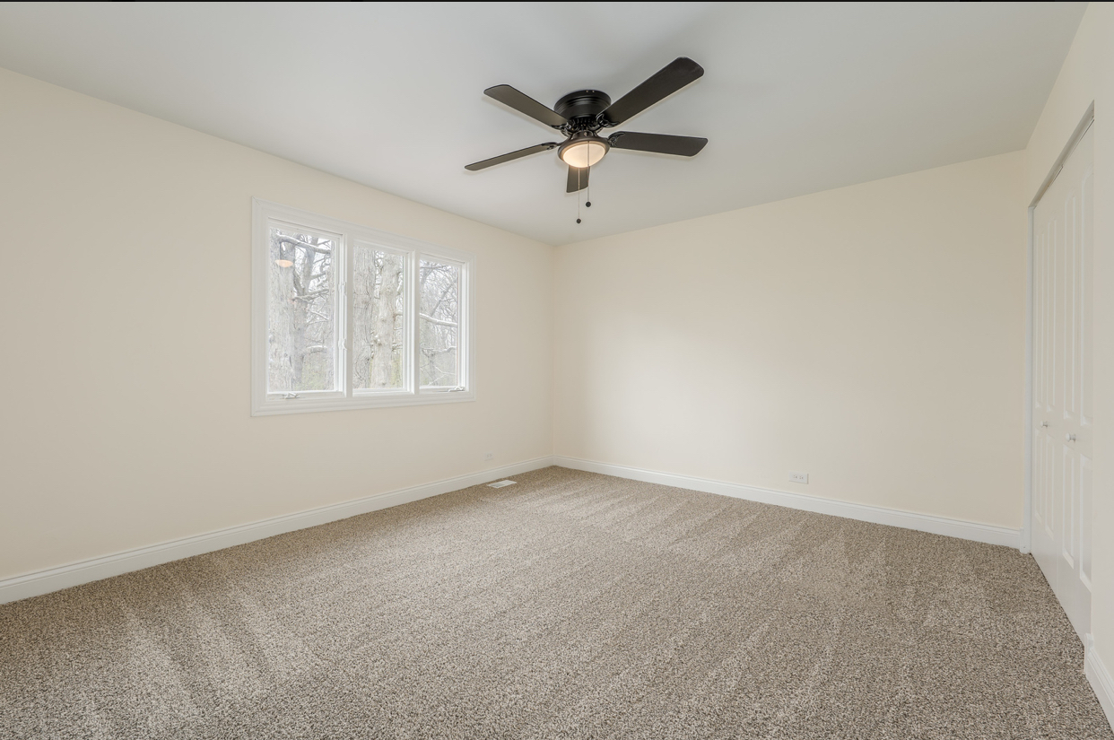 3664 Edward Drive Crete, IL 60417 - Photo 19 of 30 an empty room with a ceiling fan and windows