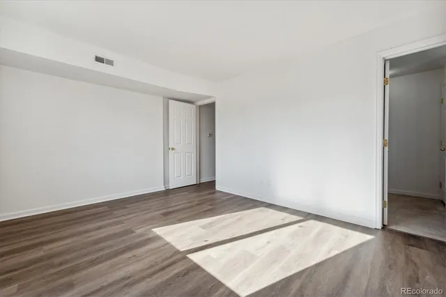an empty room with wooden floor