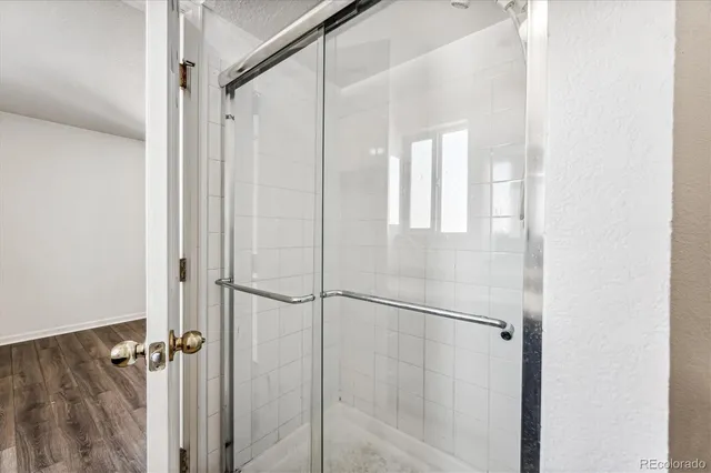 a bathroom with a glass shower door
