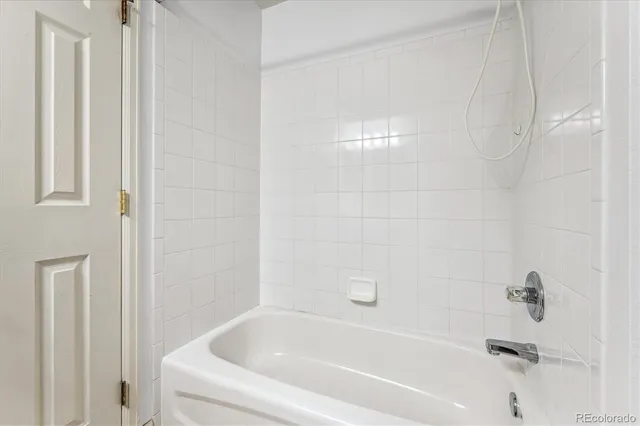 a white bath tub sitting next to a white wooden tub