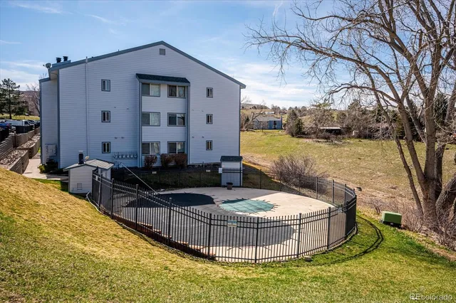 a view of a house with backyard and sitting area