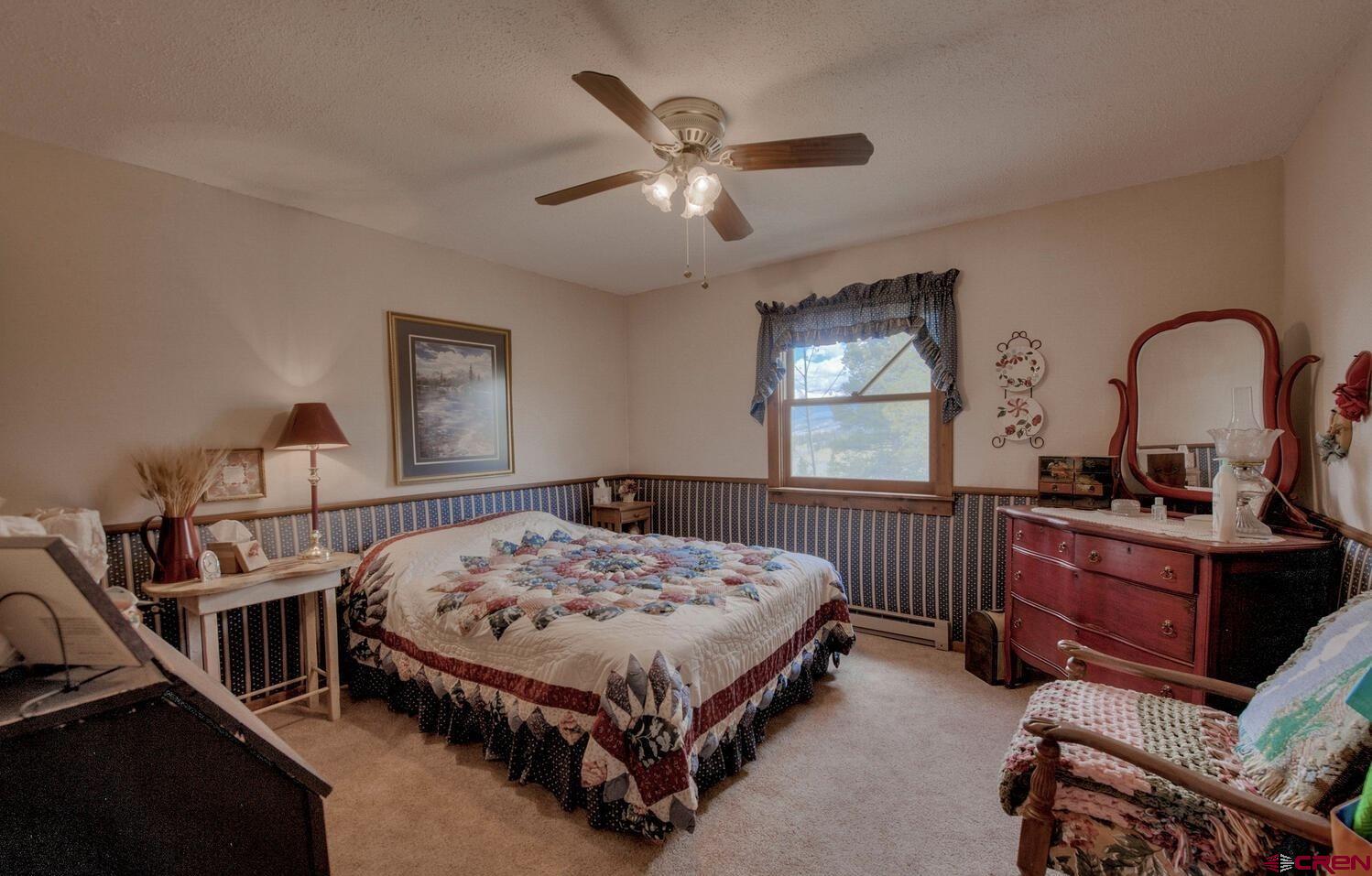 1499 Lake County Road Twin Lakes, CO 81251 - Photo 12 of 37 a bedroom with a bed window and dresser