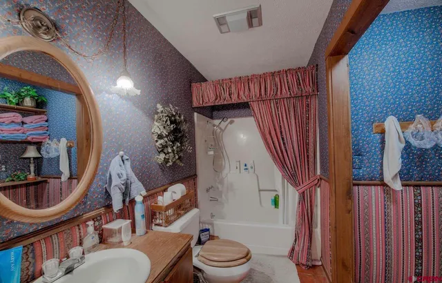 a view of a house with a yard covered in snow