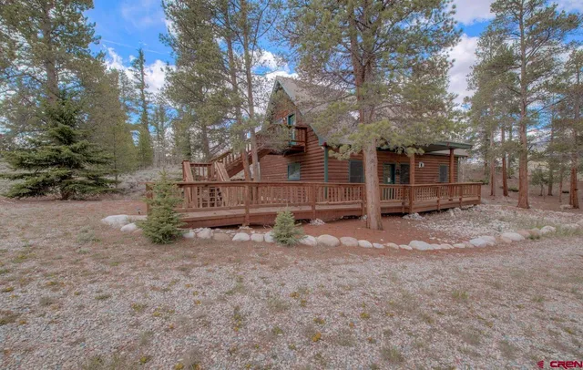 a view of a balcony with a yard
