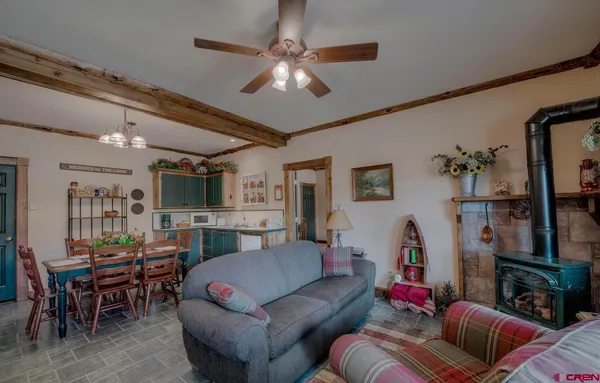 a living room with furniture a chandelier and a flat screen tv