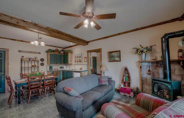 a living room with furniture a chandelier and a flat screen tv