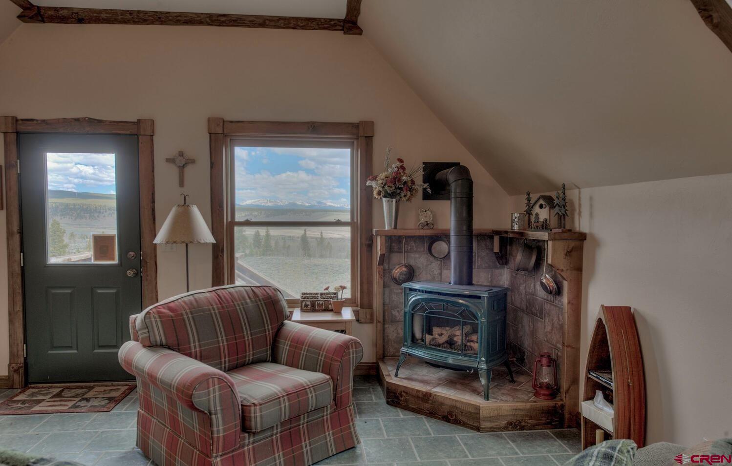 1499 Lake County Road Twin Lakes, CO 81251 - Photo 21 of 37 a living room with furniture and a fireplace