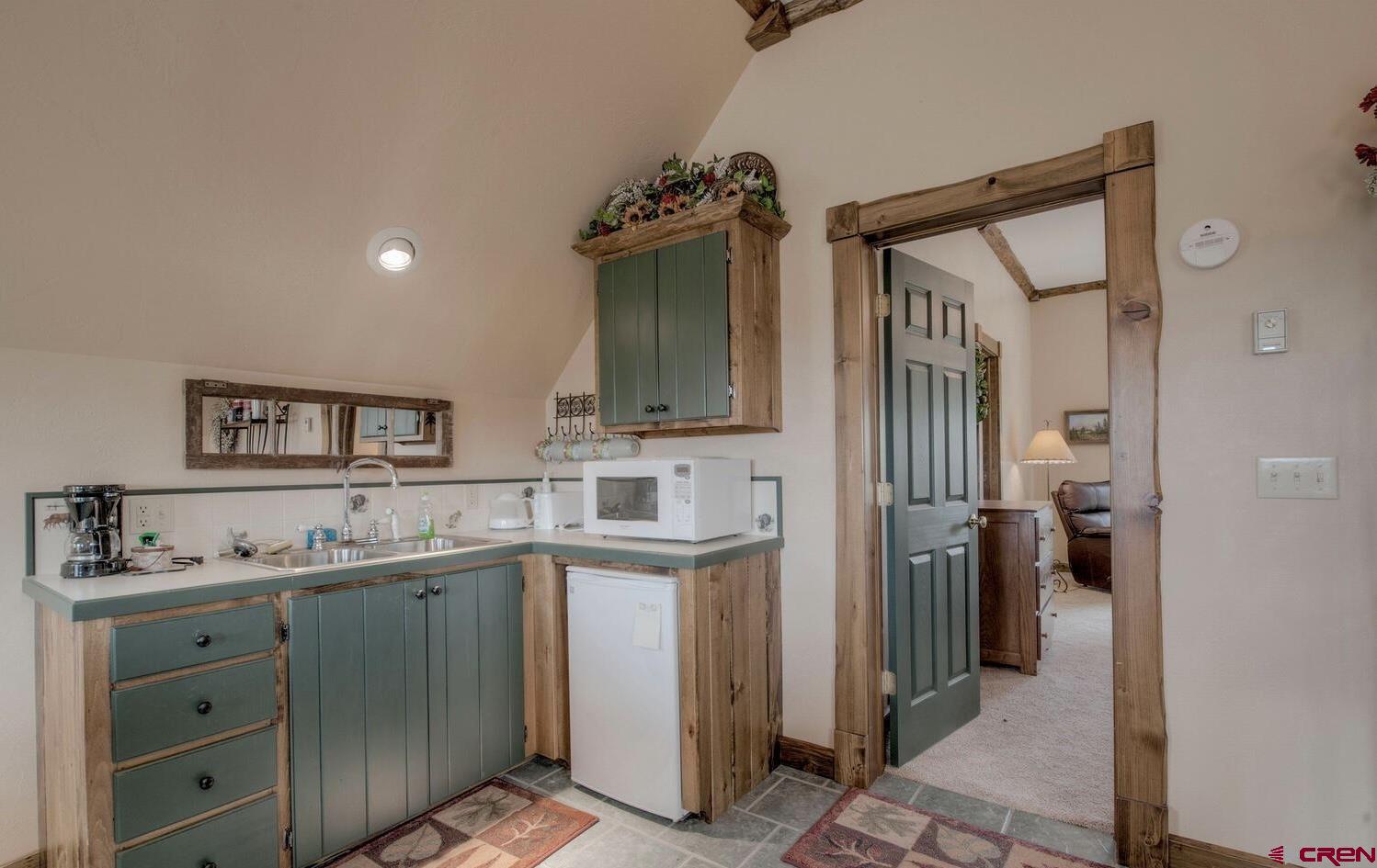 1499 Lake County Road Twin Lakes, CO 81251 - Photo 22 of 37 a kitchen with a refrigerator and a sink