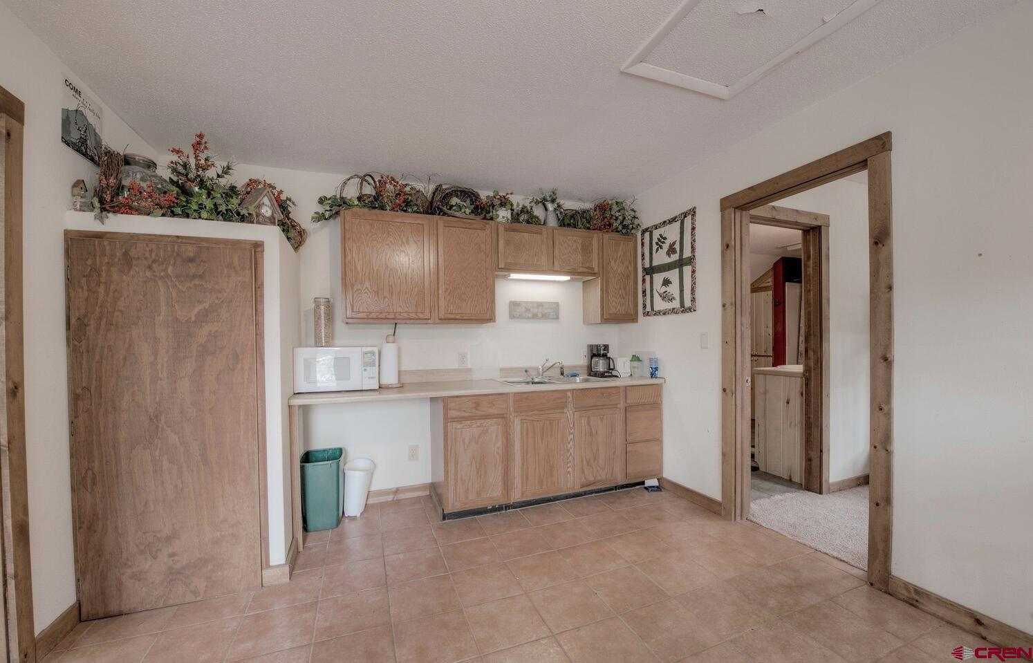 1499 Lake County Road Twin Lakes, CO 81251 - Photo 28 of 37 a kitchen with granite countertop a refrigerator and a sink