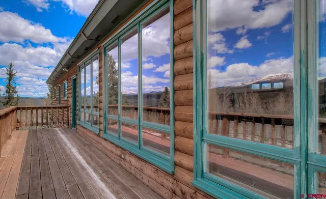 a view of a porch with a furniture and floor to ceiling window