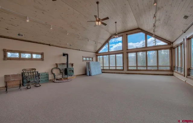 a room with stainless steel appliances kitchen island granite countertop furniture and a large window