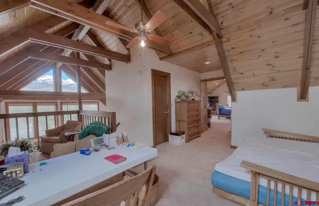 a bedroom with furniture and large windows