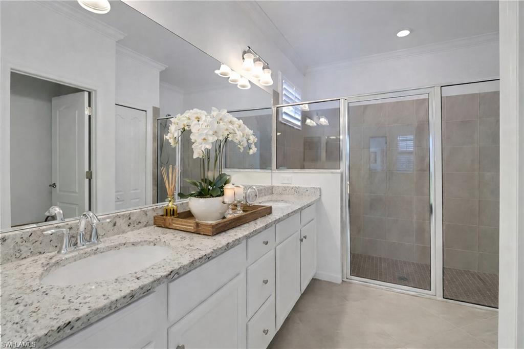 17609 Ashcomb Way Estero, FL 33928 - Photo 11 of 40 Full bathroom featuring double vanity, a stall shower, ornamental molding, and recessed lighting