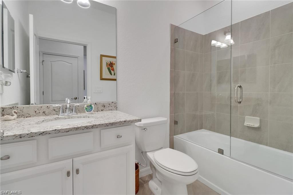 17609 Ashcomb Way Estero, FL 33928 - Photo 13 of 40 Bathroom with vanity and combined bath / shower with glass door