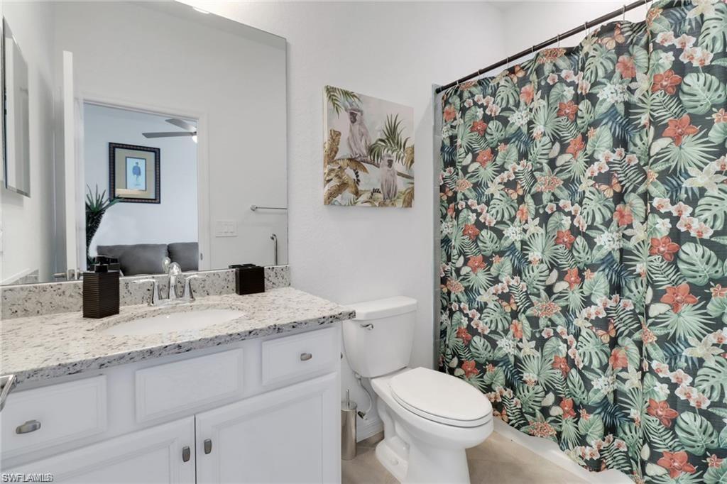 17609 Ashcomb Way Estero, FL 33928 - Photo 15 of 40 Bathroom with vanity and curtained shower