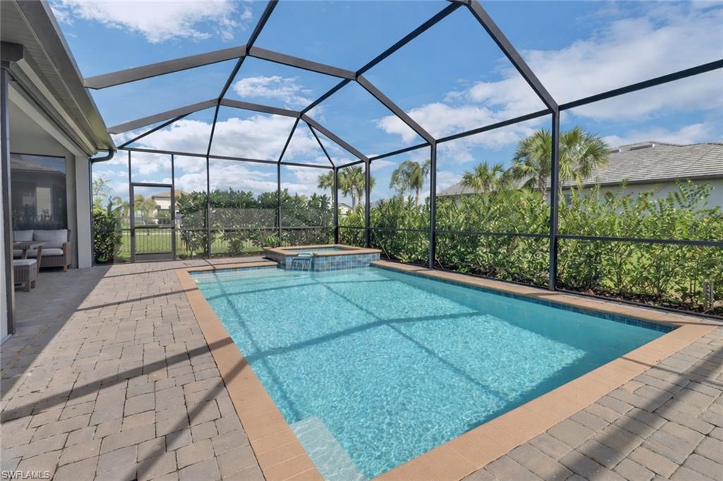 17609 Ashcomb Way Estero, FL 33928 - Photo 18 of 40 Relaxing pool / spa with a lanai, a sunroom, and a patio area
