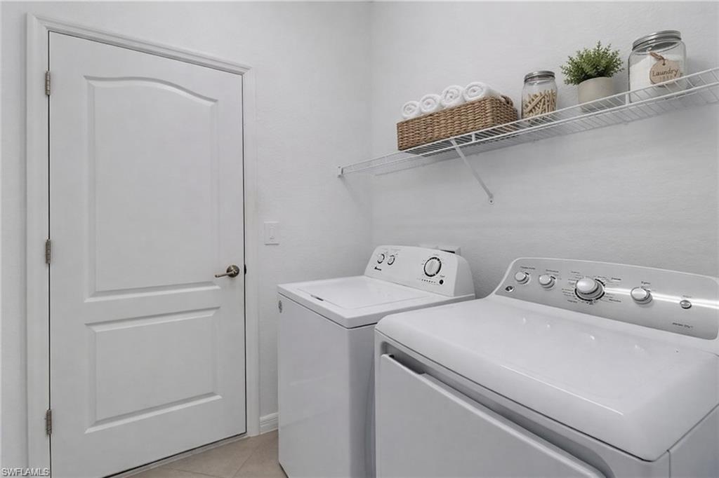 17609 Ashcomb Way Estero, FL 33928 - Photo 20 of 40 Laundry room featuring washer and clothes dryer and light tile patterned floors