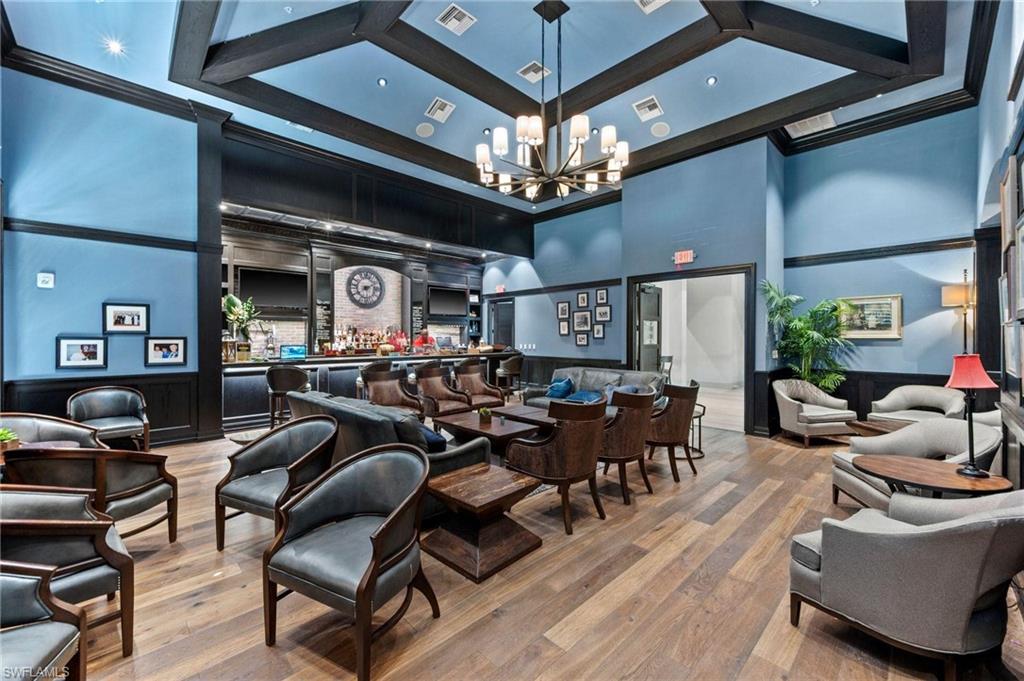 17609 Ashcomb Way Estero, FL 33928 - Photo 33 of 40 Common area featuring wainscoting, ornamental molding, a decorative wall, and a high ceiling