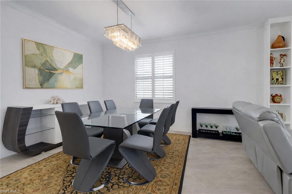 17609 Ashcomb Way Estero, FL 33928 - Photo 9 of 40 Dining room featuring hanging lights and crown molding