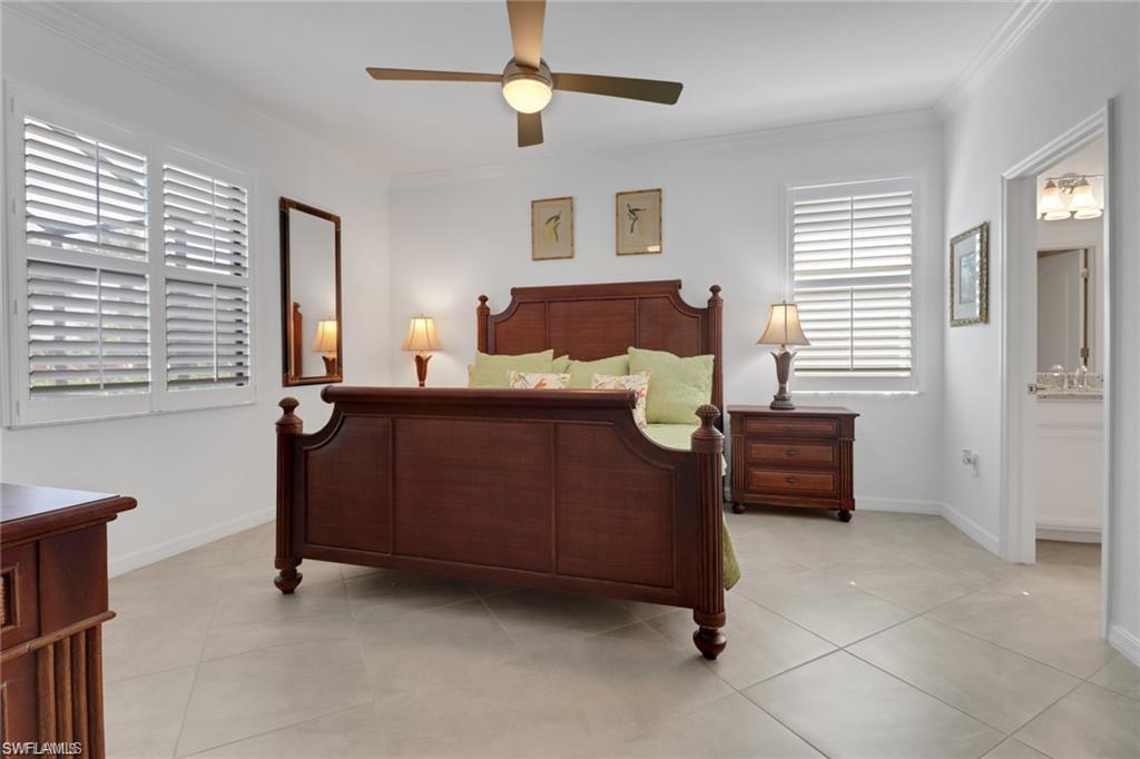 17609 Ashcomb Way Estero, FL 33928 - Photo 10 of 40 Bedroom featuring ornamental molding, connected bathroom, a ceiling fan, and light tile patterned floors