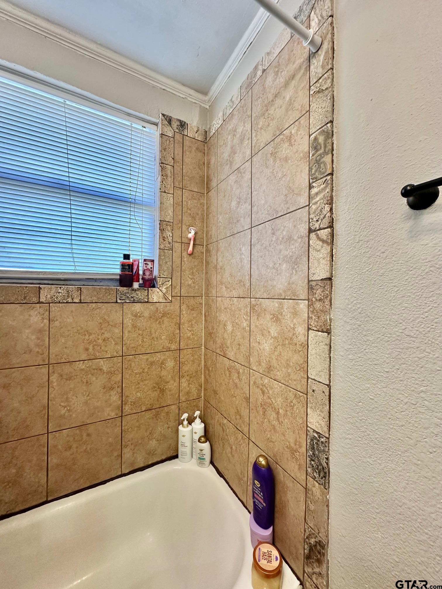 2601 East George Richey Road Longview, TX 75604 - Photo 20 of 26 a bathroom with a bathtub and shower