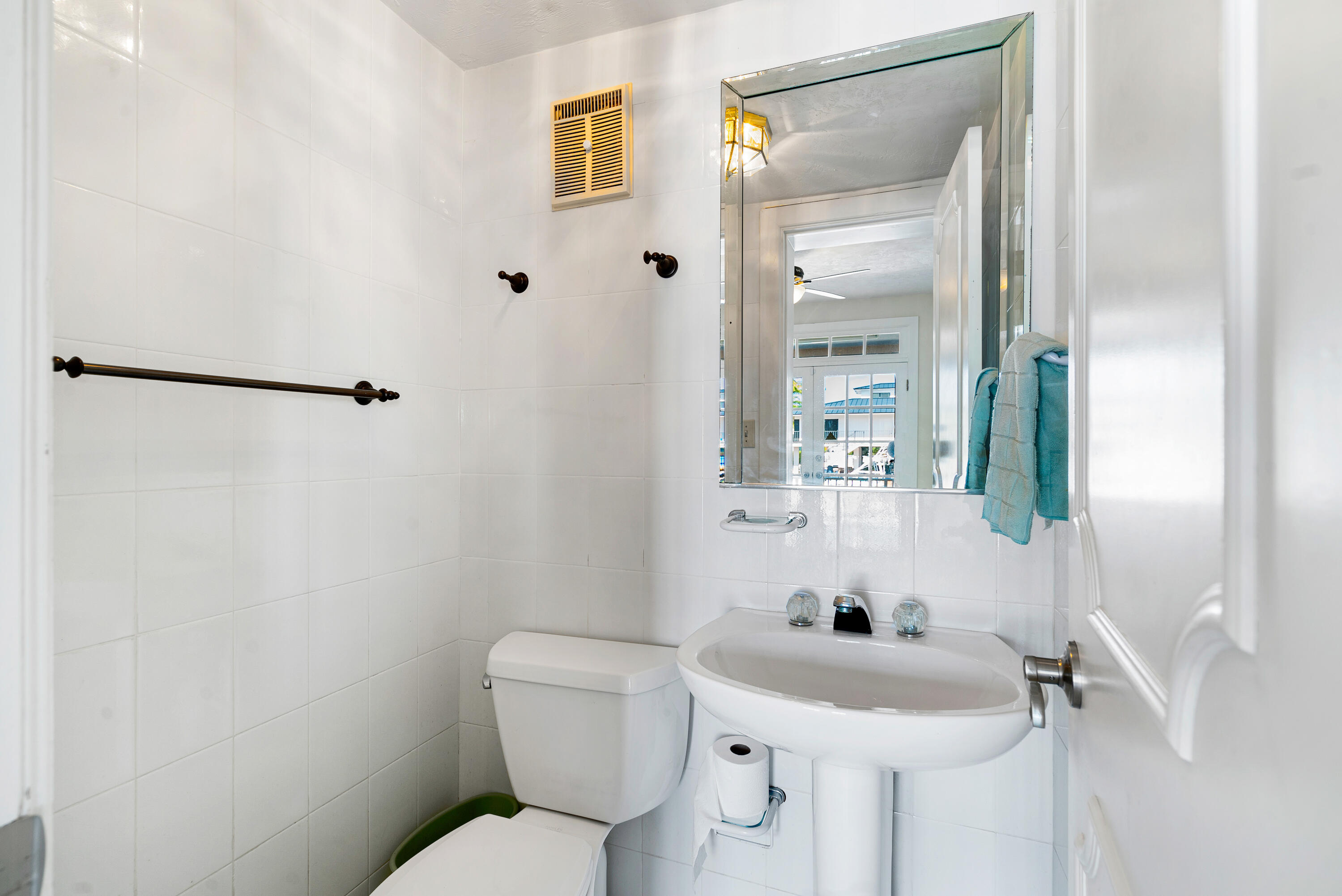 239 Atlantic Boulevard Key Largo, FL 33037 - Photo 12 of 50 a bathroom with a sink mirror and toilet