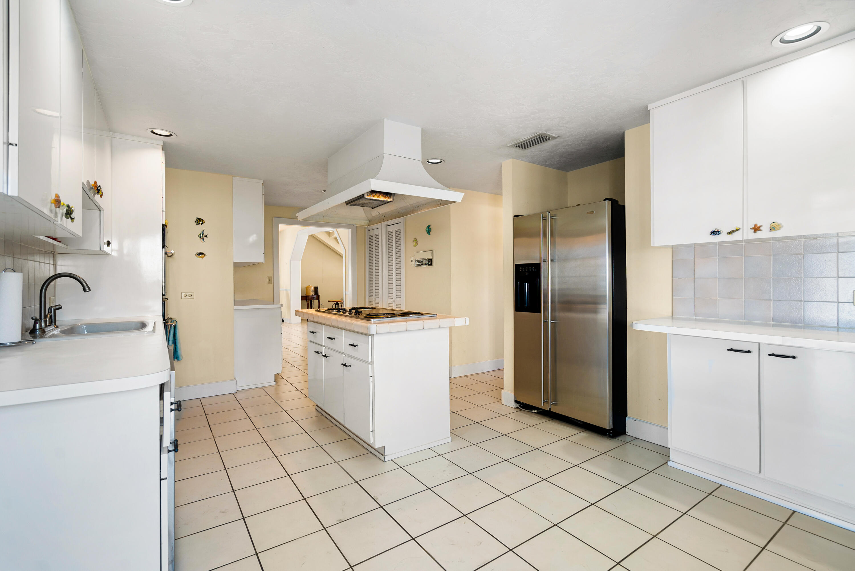 239 Atlantic Boulevard Key Largo, FL 33037 - Photo 15 of 50 a kitchen with a refrigerator sink and cabinets