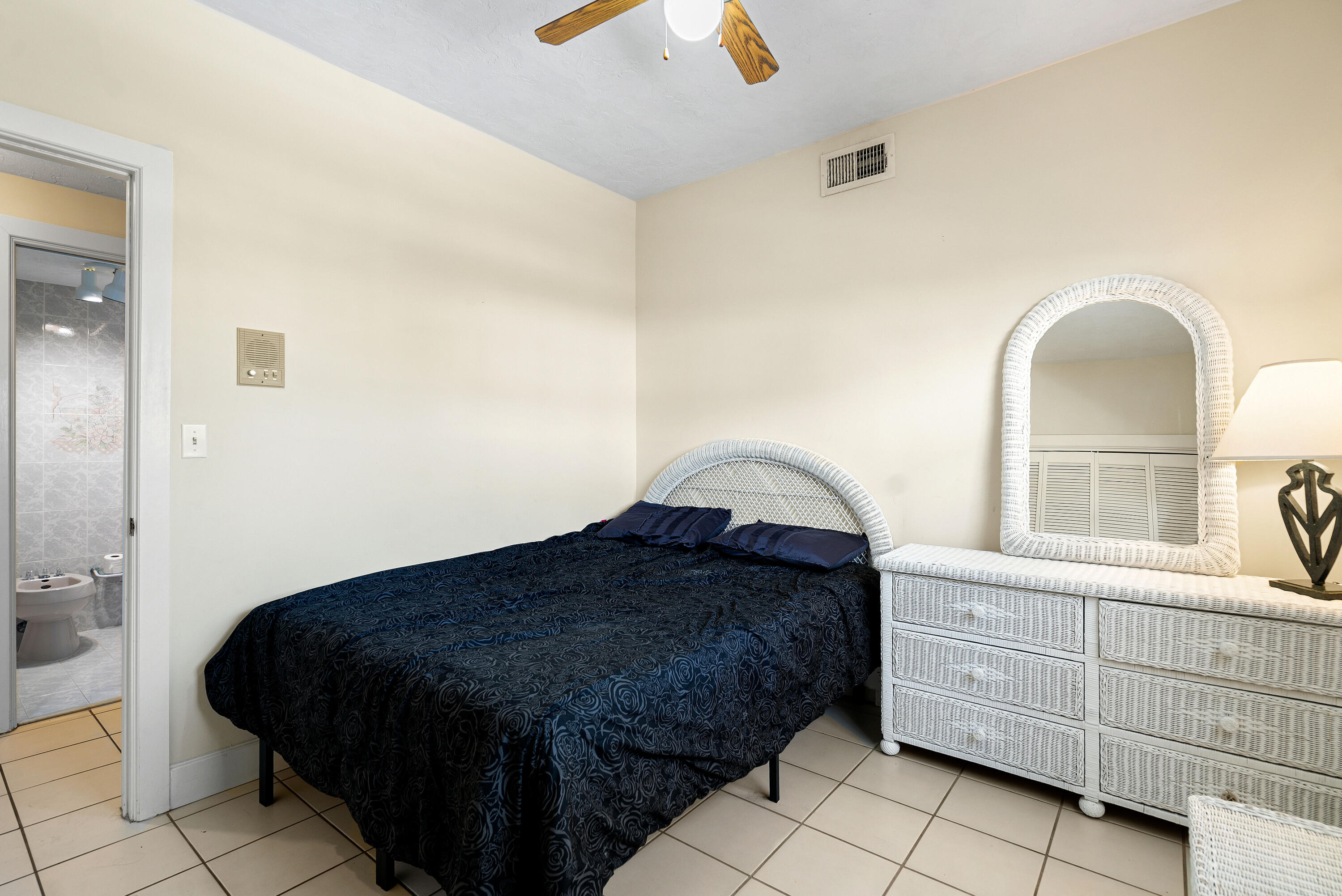 239 Atlantic Boulevard Key Largo, FL 33037 - Photo 18 of 50 a bedroom with a bed and a dresser