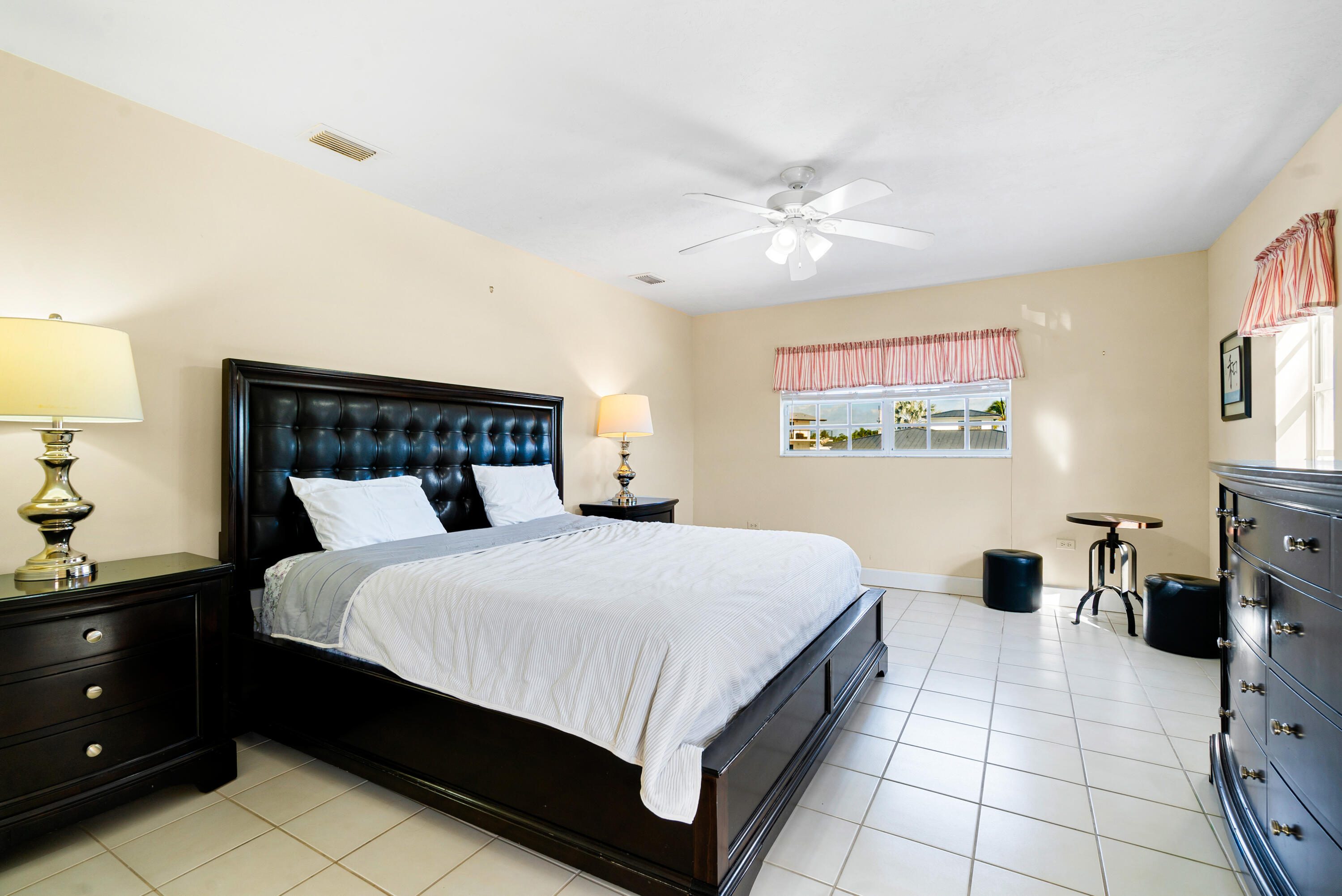 239 Atlantic Boulevard Key Largo, FL 33037 - Photo 24 of 50 a bedroom with a bed and a chandelier