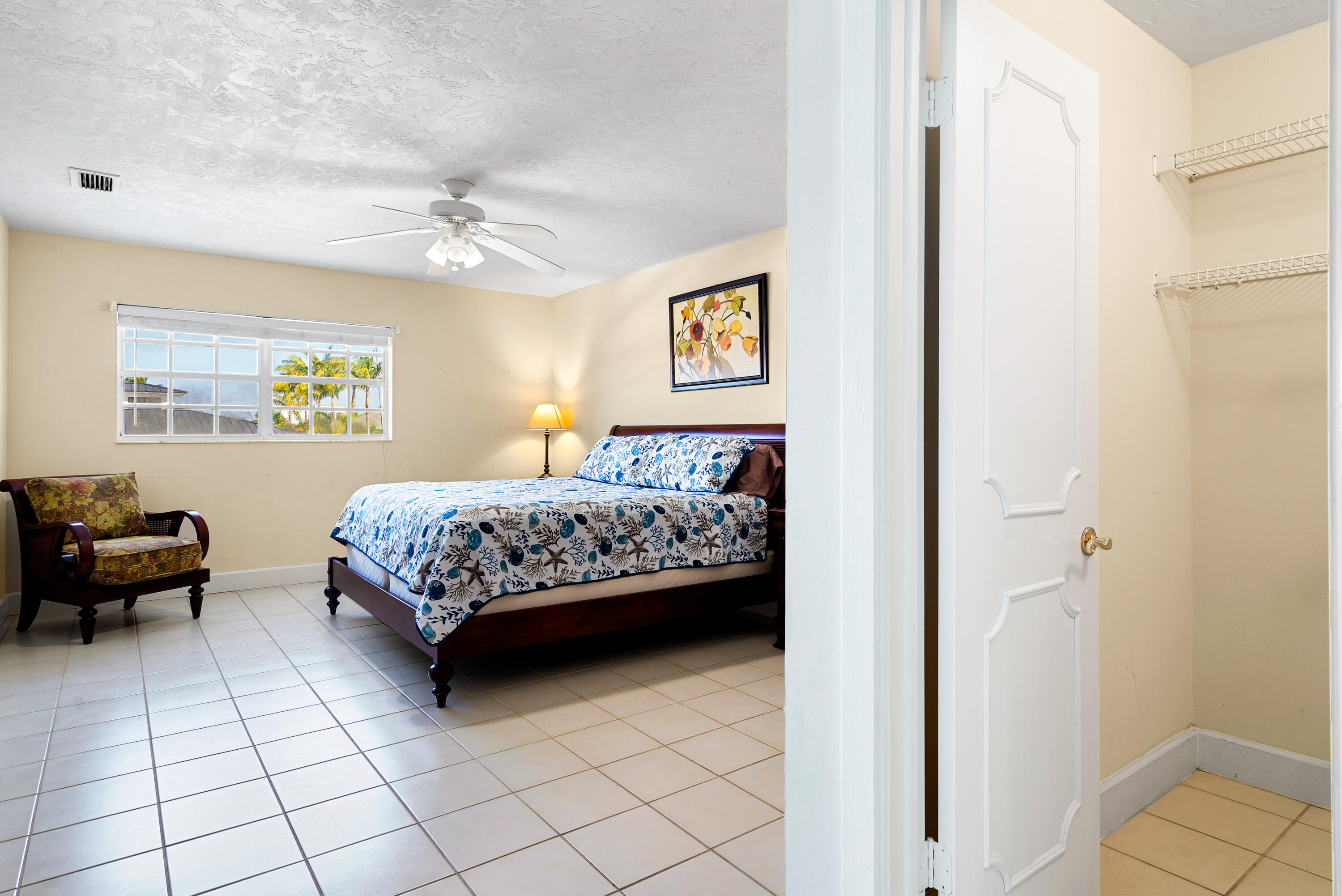 239 Atlantic Boulevard Key Largo, FL 33037 - Photo 28 of 50 a bedroom with a bed and a table in it with wooden floor