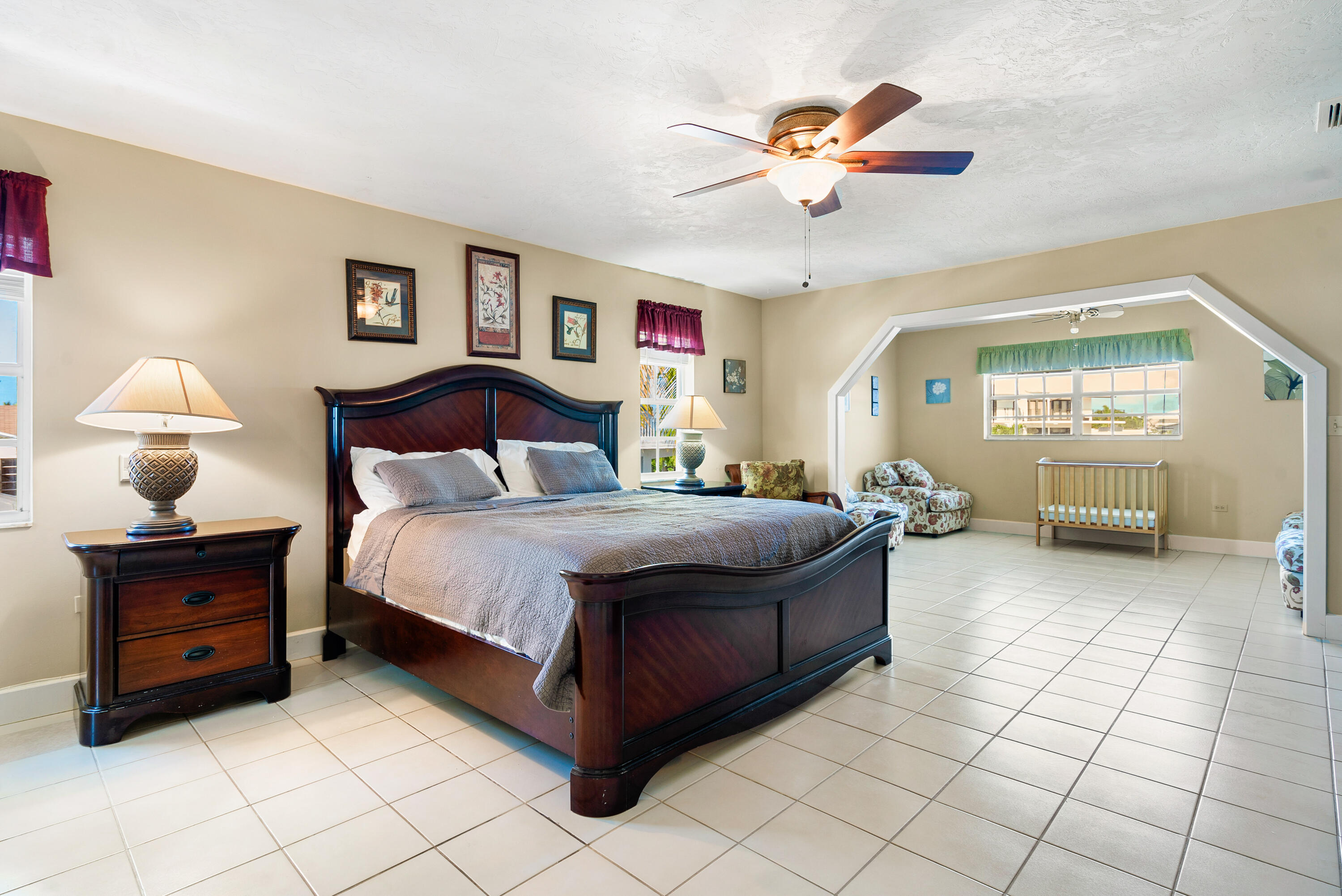 239 Atlantic Boulevard Key Largo, FL 33037 - Photo 31 of 50 a bedroom with a bed and a chandelier