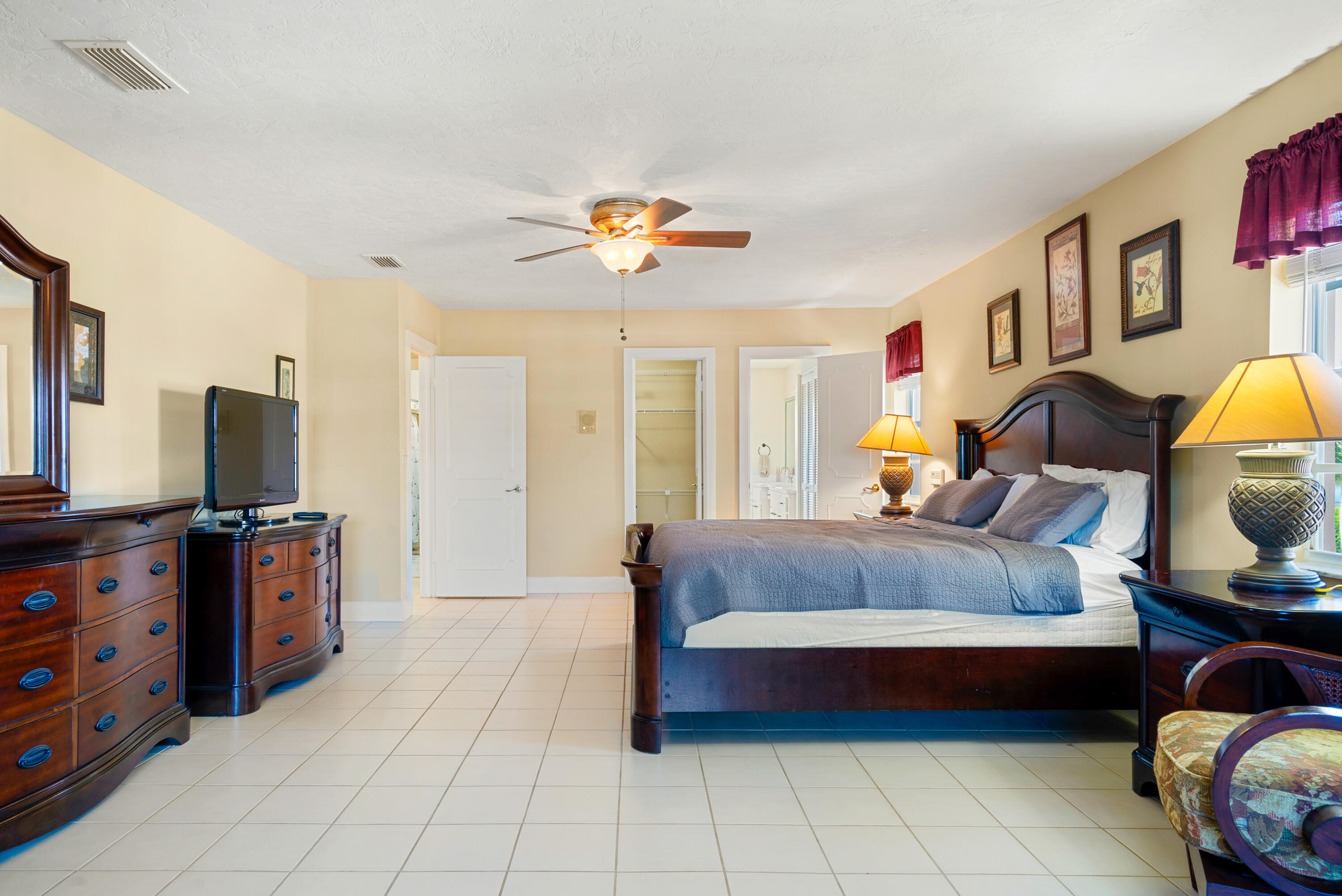 239 Atlantic Boulevard Key Largo, FL 33037 - Photo 33 of 50 a bedroom with a bed and wooden floor