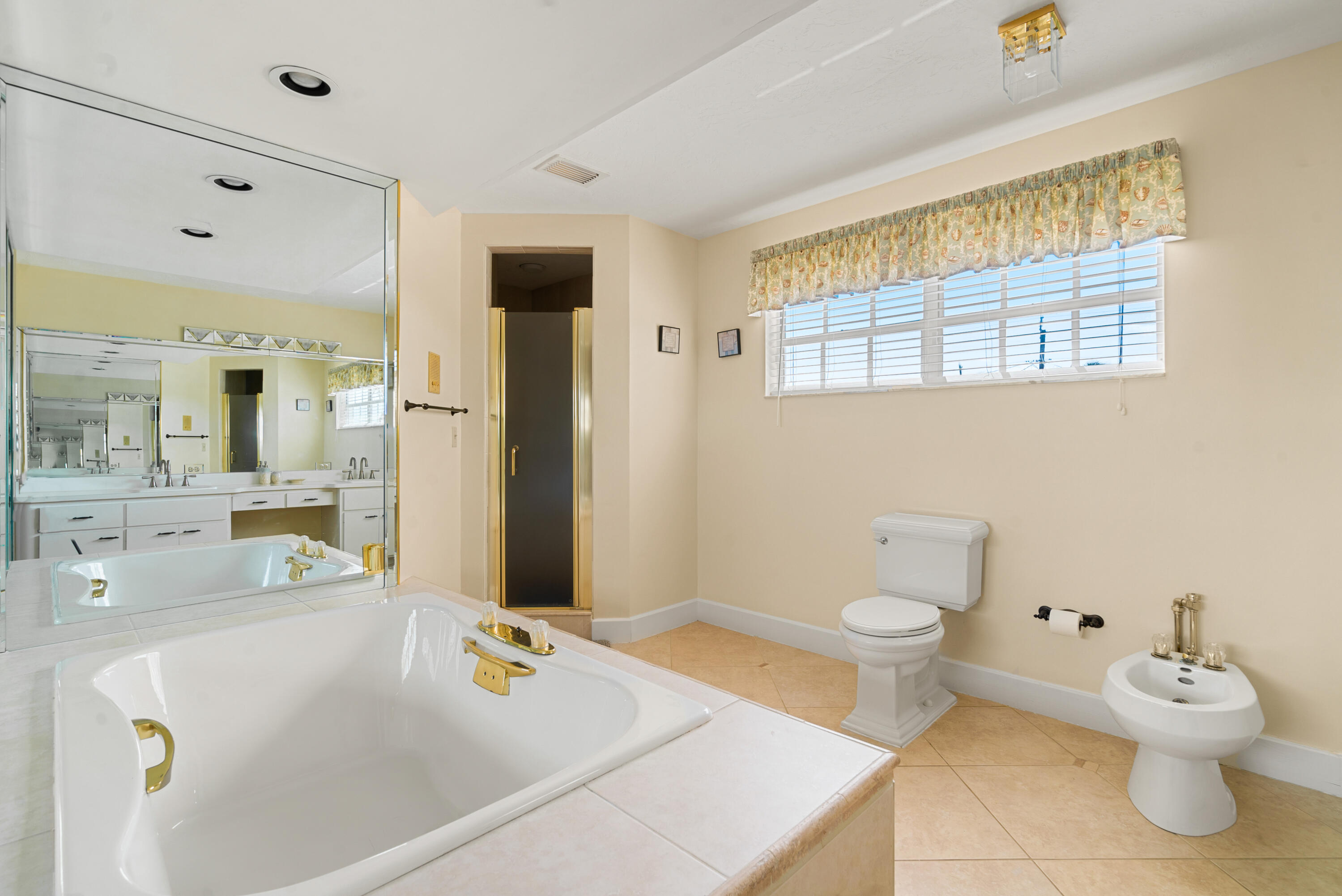 239 Atlantic Boulevard Key Largo, FL 33037 - Photo 35 of 50 a bathroom with a sink a toilet and a mirror