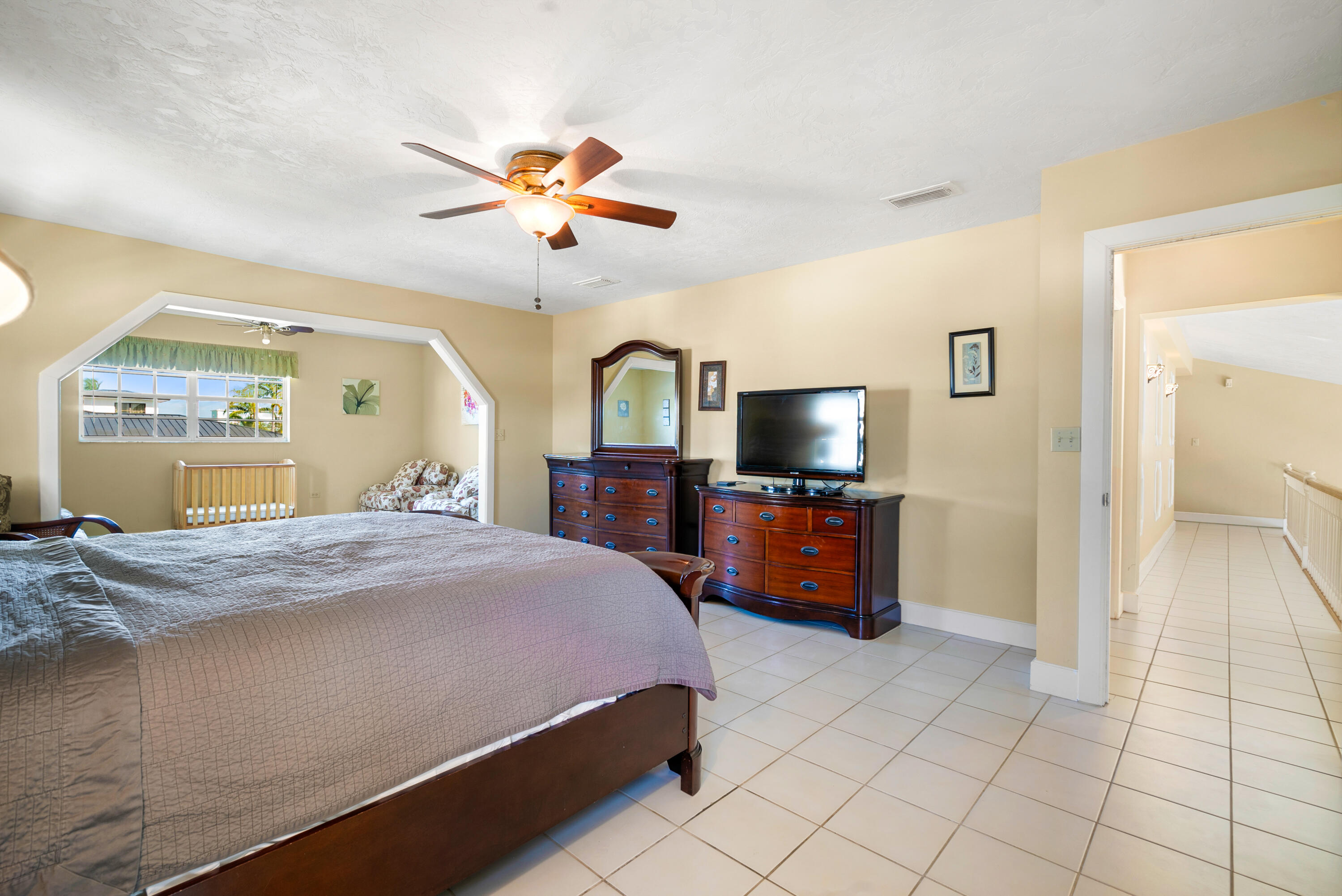 239 Atlantic Boulevard Key Largo, FL 33037 - Photo 37 of 50 a bedroom with a bed and wooden floor