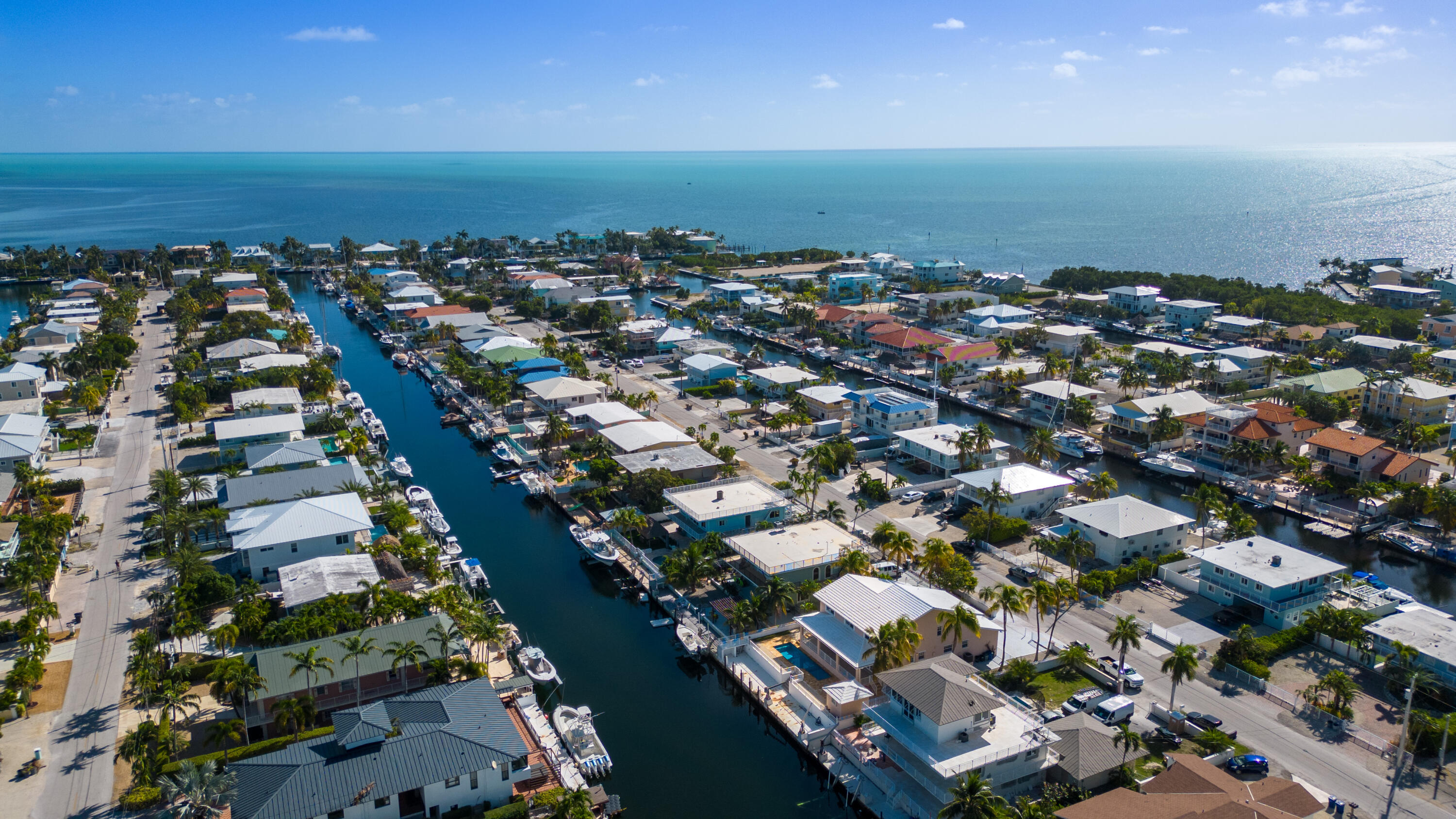 239 Atlantic Boulevard Key Largo, FL 33037 - Photo 45 of 50 an aerial view of a city with lots of residential buildings ocean and mountain view in back