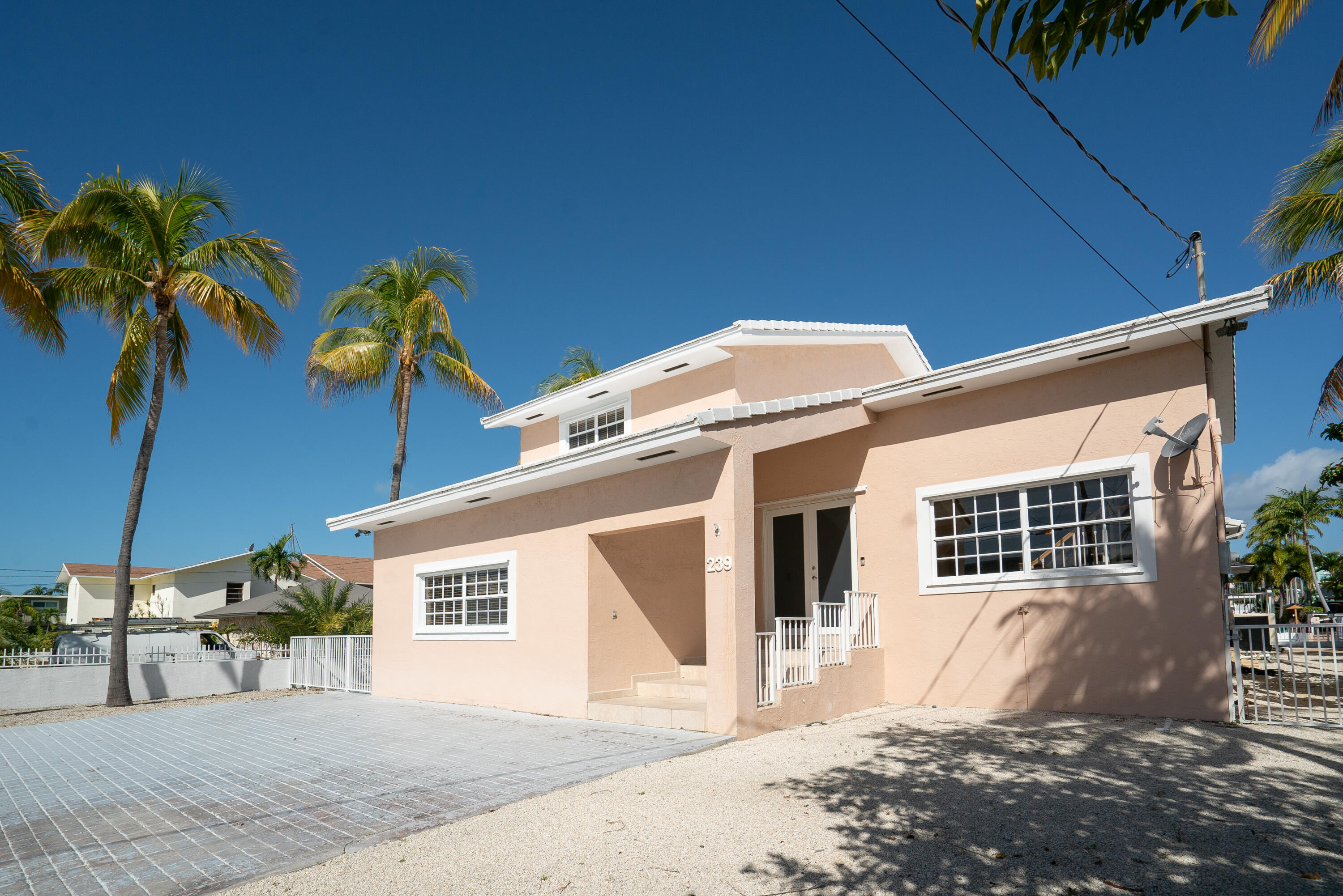 239 Atlantic Boulevard Key Largo, FL 33037 - Photo 49 of 50 a front view of a house with a yard