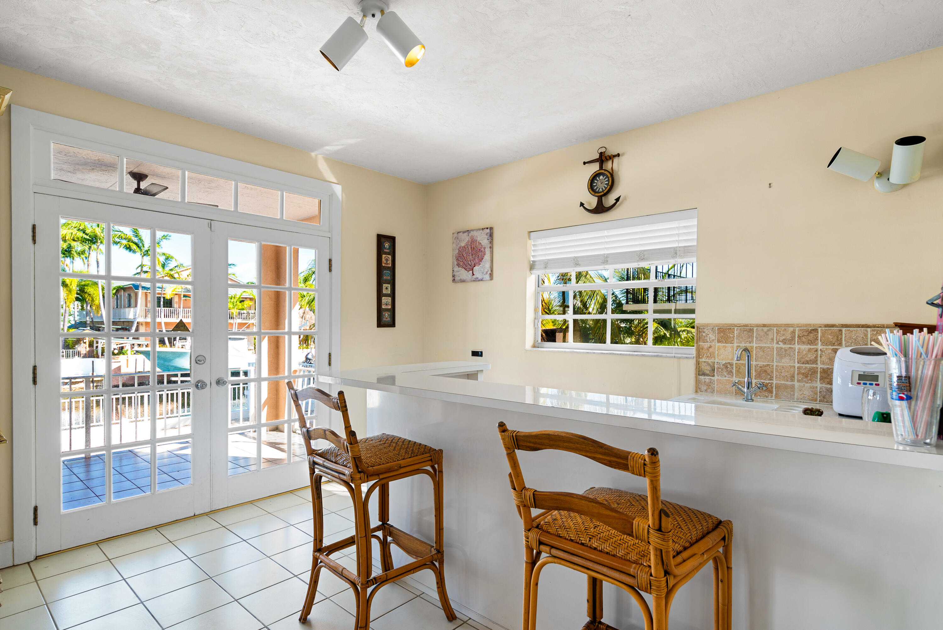 239 Atlantic Boulevard Key Largo, FL 33037 - Photo 9 of 50 a living room with a large window and furniture