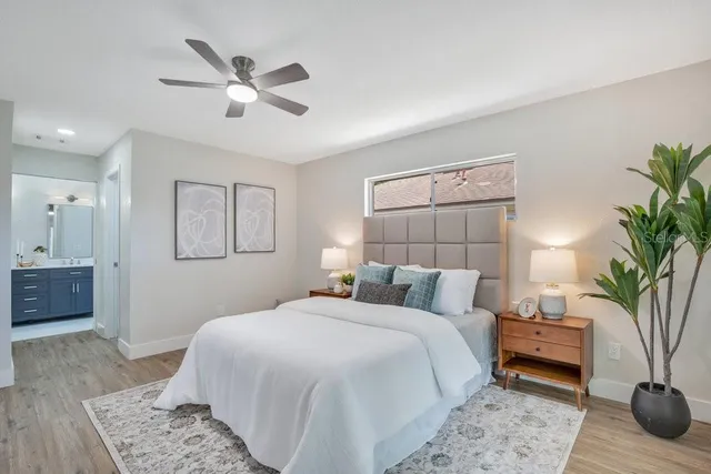 a bedroom with a large bed and a chandelier