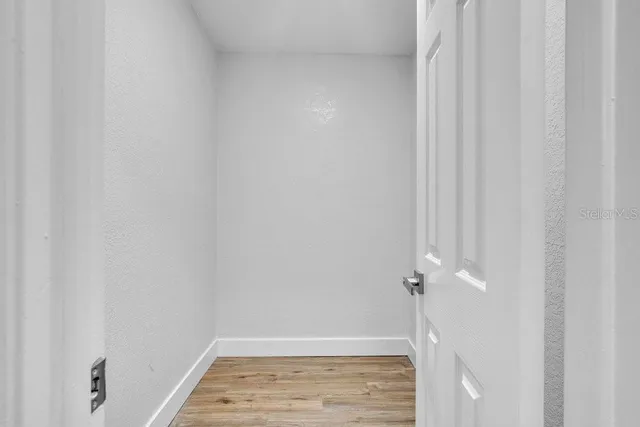 a bathroom with a granite countertop sink a toilet a mirror and shower