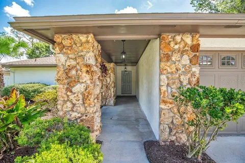 a view of house with backyard and outdoor seating