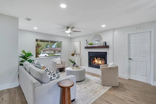 a living room with furniture and a fireplace
