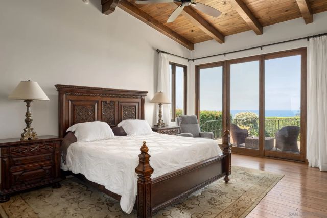 a bedroom with a large bed and a large window