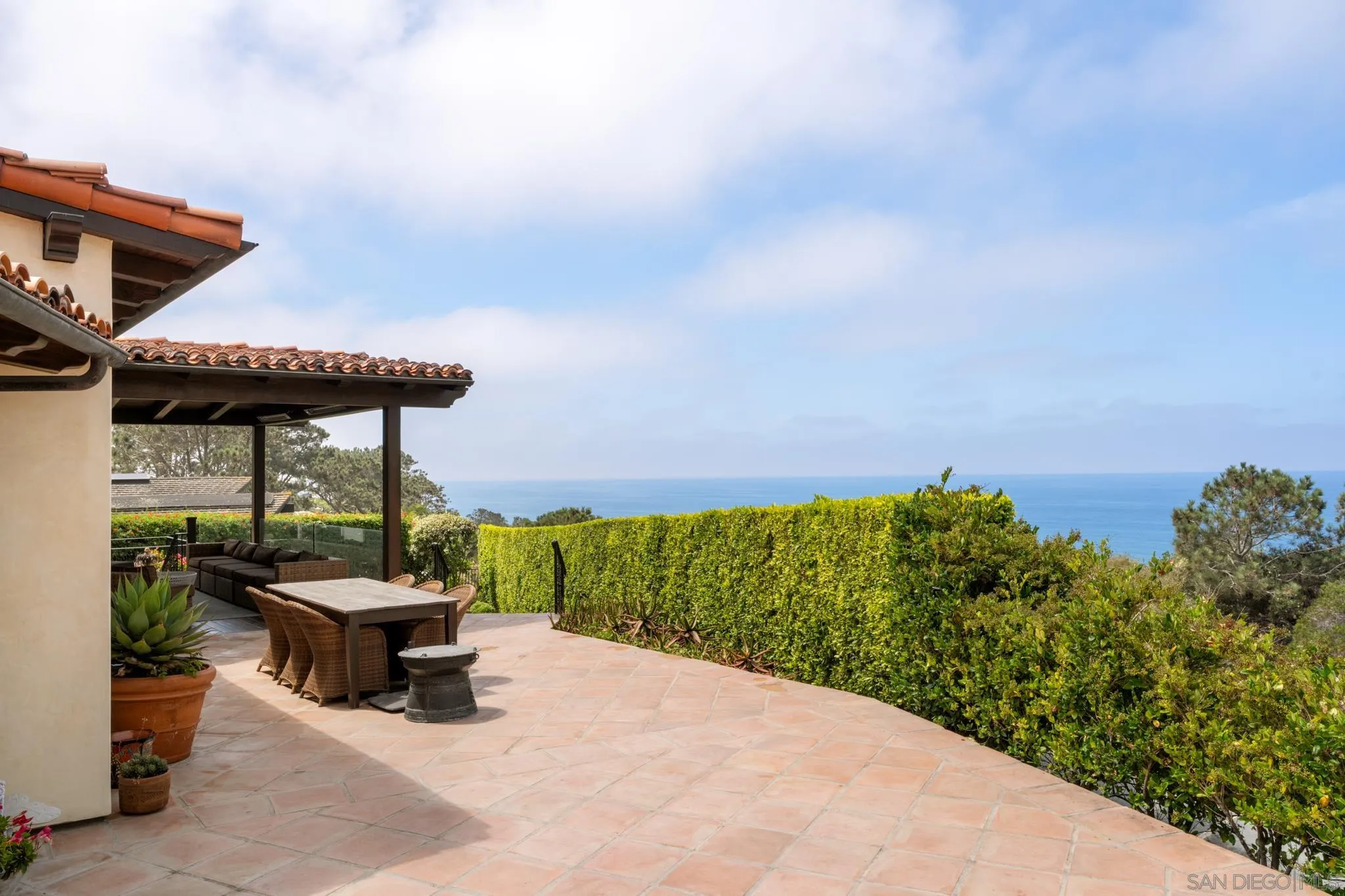 262 Ocean View Avenue Del Mar, CA 92014 - Photo 37 of 45 a backyard of a house with table and chairs