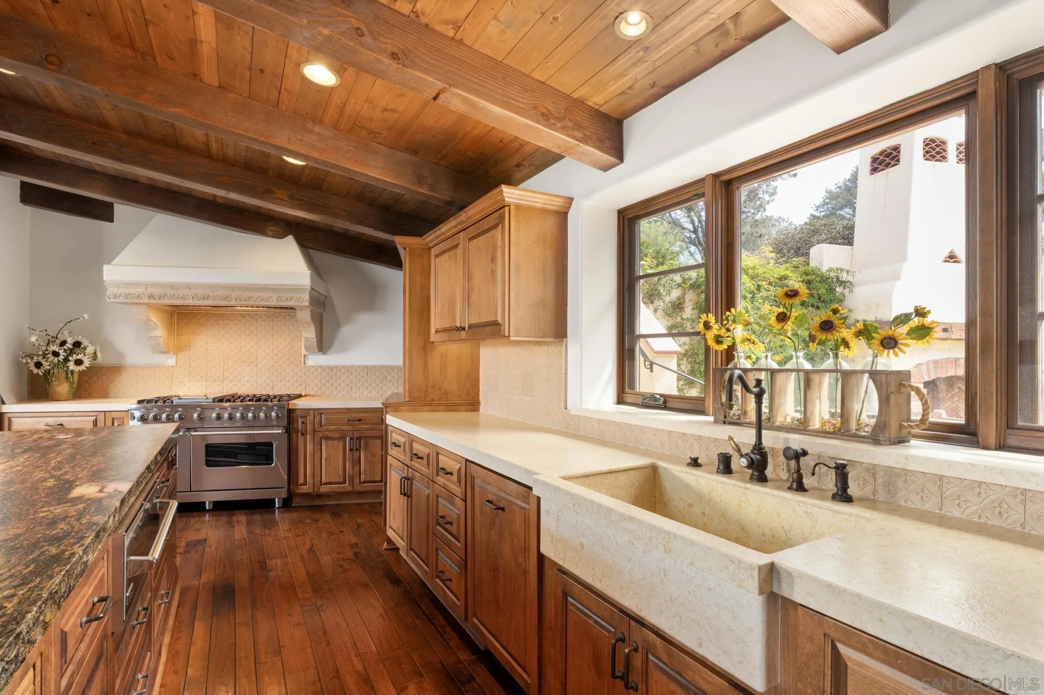 262 Ocean View Avenue Del Mar, CA 92014 - Photo 10 of 45 a kitchen with a stove a sink and wooden cabinets
