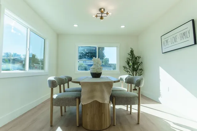 a view of a dining room with furniture and a window