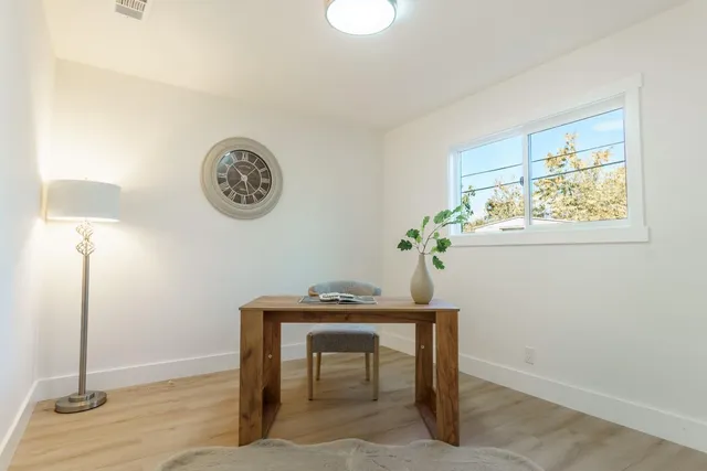 a view of room with window and wooden floor