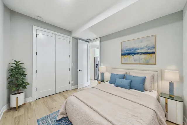 a bedroom with bed and wooden floor