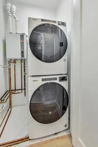 a utility room with wooden floor and mirror
